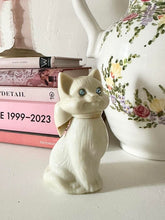 Load image into Gallery viewer, 1970s Milk Glass Kitty Cat Bow Perfume Bottle by Avon
